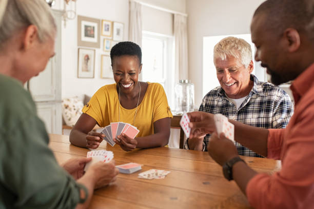 Group of middle aged couples playing cards