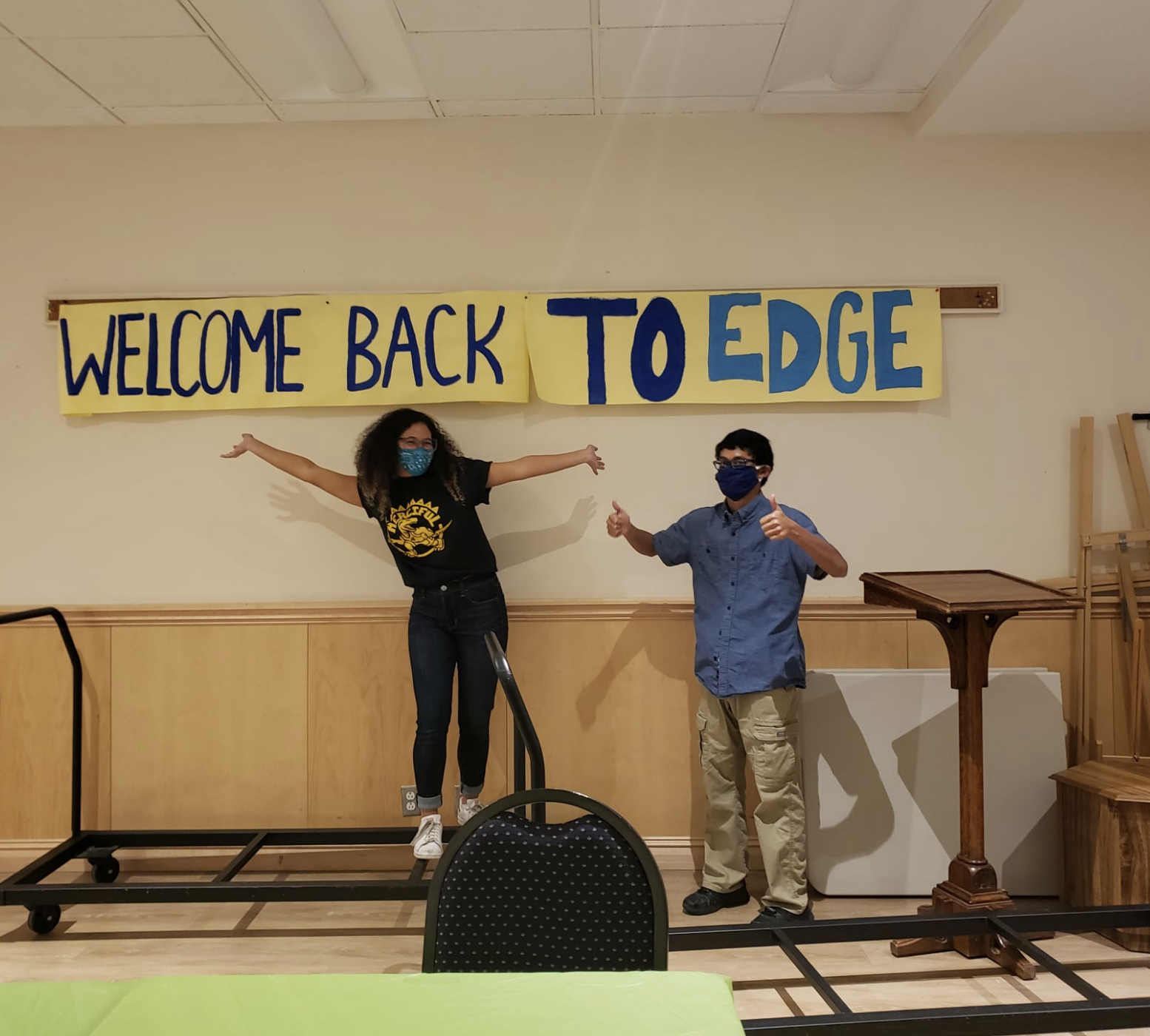 Two teens in front of a "Welcome back to EDGE" sign