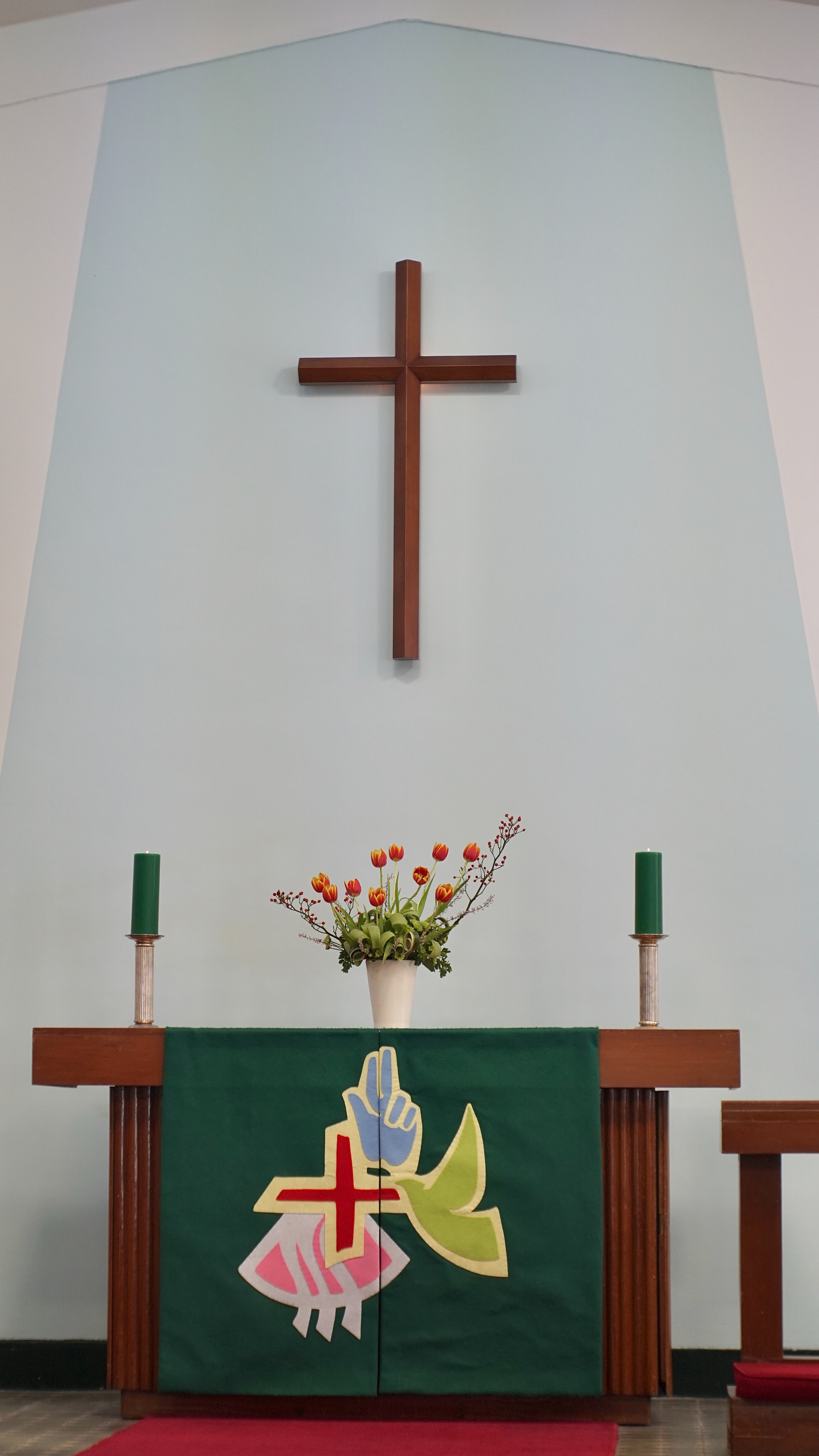Simple altar with thin brown cross over top